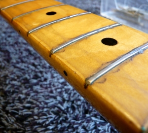 re-fretting & fret dress: Maple finger board with worn frets that need replacing. 