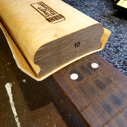 Removing grooves from a fingerboard: